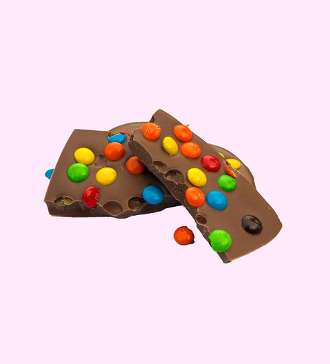 Creamy Belgian milk chocolate heart topped with colourful M&M® s, perfect for gifting or treating yourself.