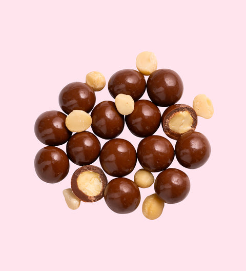 Crunchy macadamias coated in smooth Belgian milk chocolate - perfect for festive gifting and snacking.