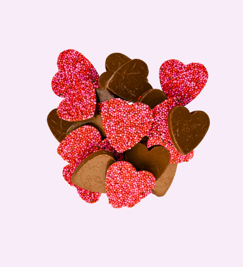 Creamy Belgian milk chocolate freckles shaped like hearts, perfect for gifting or celebrating special moments.