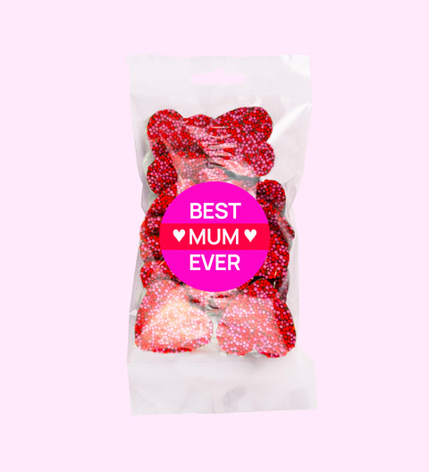 Creamy Belgian milk chocolate freckles shaped like hearts, topped with pink and red freckles with "Best Mum Ever" sticker. Perfect for gifting or celebrating mum's special moments.