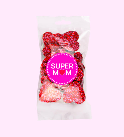 Creamy Belgian milk chocolate freckles shaped like hearts, topped with pink and red freckles with "Super Mum" sticker. Perfect for gifting or celebrating mum's special moments.