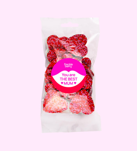 Creamy Belgian milk chocolate freckles shaped like hearts, topped with pink and red freckles with "You are the Best Mum" sticker. Perfect for gifting or celebrating mum's special moments.