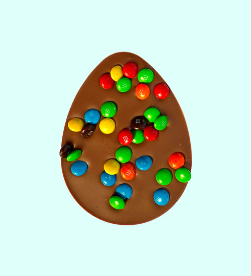 Smooth Belgian milk chocolate egg filled and topped with colourful mini M&Ms, perfect for a fun and tasty Easter treat.