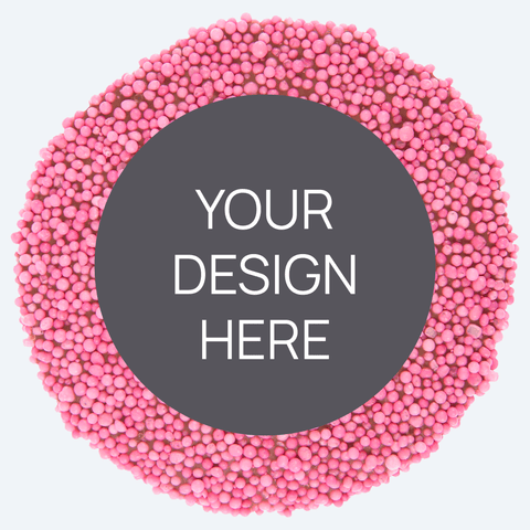 A custom product featuring a single round confectionery item with a colorful sprinkled border and a blank space in the center for a custom label, displayed alongside a selection of other colored sprinkles.