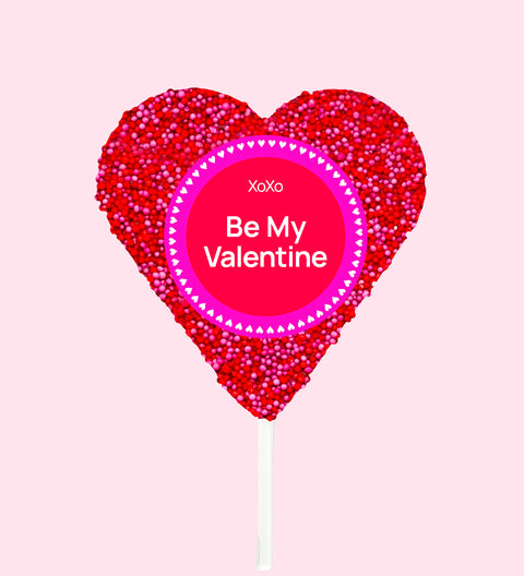 Heart-shaped lollipop with 'Be My Valentine' text on a pink background