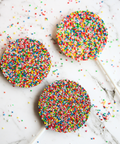 Creamy Belgian milk chocolate pop covered in colourful sprinkles.