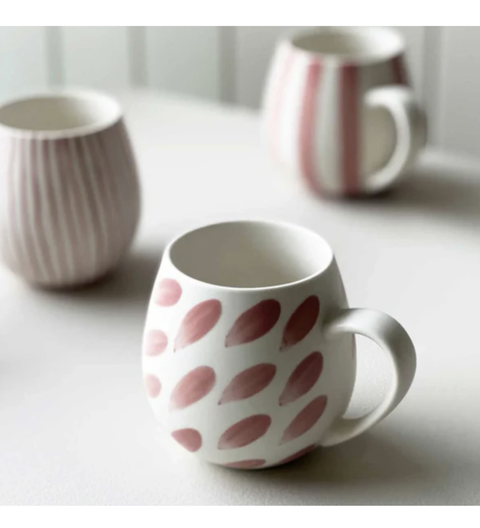 Pink brushstroke stoneware mugs stacked with rounded shape and handles