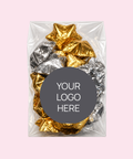 A clear plastic bag containing crumpled metallic gold and silver foil pieces, centered on a pale pink background with a dark gray circular label that reads 'YOUR LOGO HERE'.
