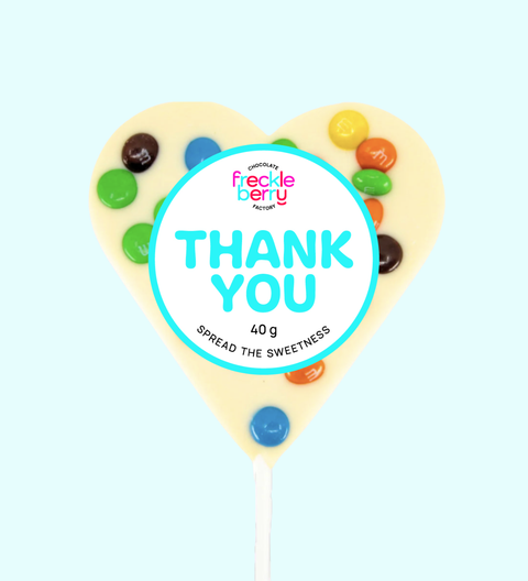 Heart-shaped lollipop with colourful candies and 'Thank You' branding on a light blue background