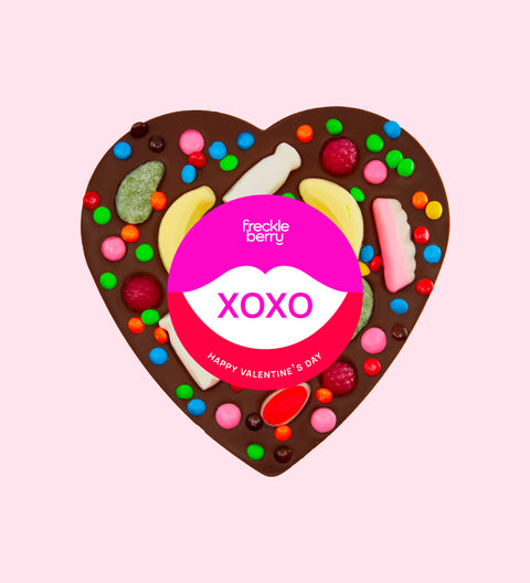 Giant heart-shaped premium Belgian dark chocolate topped with colourful lollies and wrapped with a cheerful XOXO sticker – a fun and delicious gift for someone special this valentine's day.