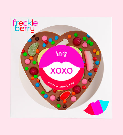 Premium giant Belgian milk chocolate topped with colourful lollies and wrapped in a cheerful "XOXO" design/label – a fun and delicious gift for someone special.