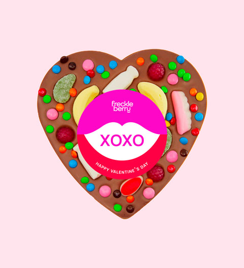 Premium giant Belgian milk chocolate topped with colourful lollies and wrapped in a cheerful "XOXO" design/label – a fun and delicious gift for someone special.