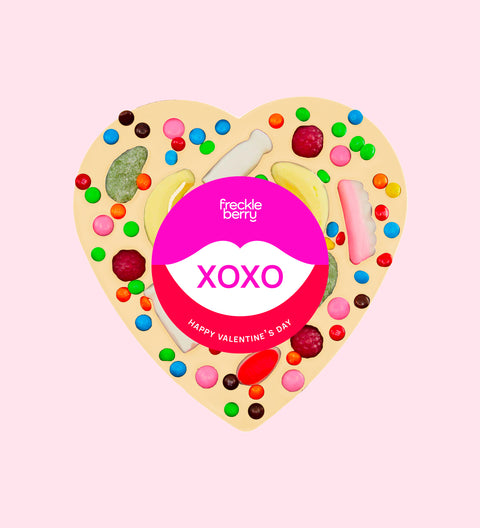 Premium giant Belgian white chocolate topped with colourful lollies and wrapped in a cheerful "XOXO" design/label – a fun and delicious gift for someone special.