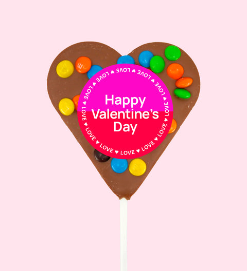 Creamy Belgian milk chocolate heart pop topped with colourful M&M®s with "Happy Valentine's Day" label/design - a sweet way to share the love.