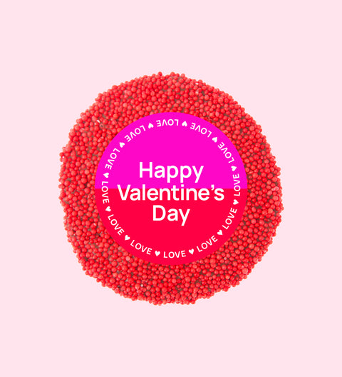 Premium Belgian chocolate topped with bright red sprinkles, wrapped in a cheerful Happy Valentine’s Day design – perfect for gifting.
