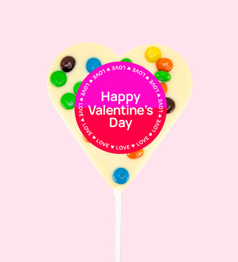 Creamy Belgian white chocolate heart pop topped with colourful M&M®s with "Happy Valentine's Day" label/design - a sweet way to share the love.
