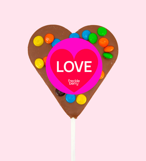 Creamy Belgian milk chocolate heart pop topped with colourful M&M®s with "Love" label/design - a sweet way to share the love.