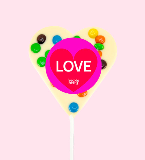 Creamy Belgian white chocolate heart pop topped with colourful M&M®s with "Love" label/design - a sweet way to share the love.