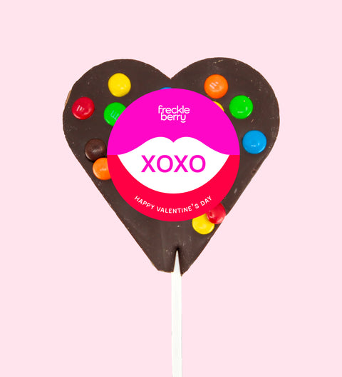 Creamy Belgian dark chocolate heart pop topped with colourful M&M®s with "XOXO" label/design - a sweet way to share the love.