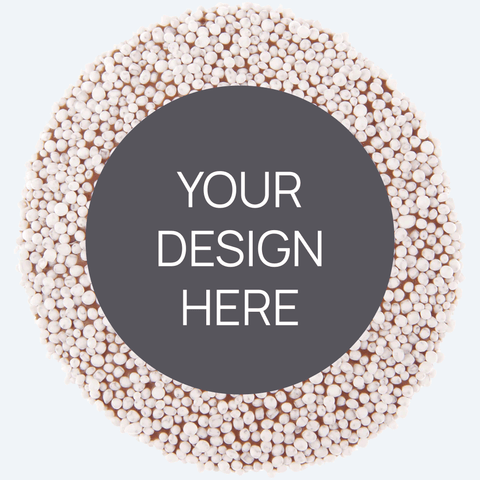 A custom product featuring a single round confectionery item with a colorful sprinkled border and a blank space in the center for a custom label, displayed alongside a selection of other colored sprinkles.