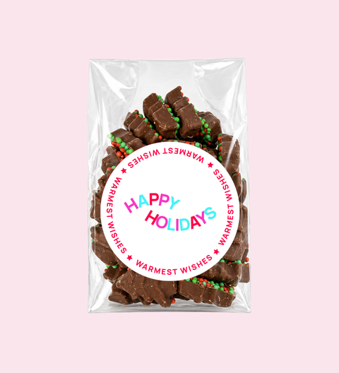 Mini xmas trees with happy holidays stickers