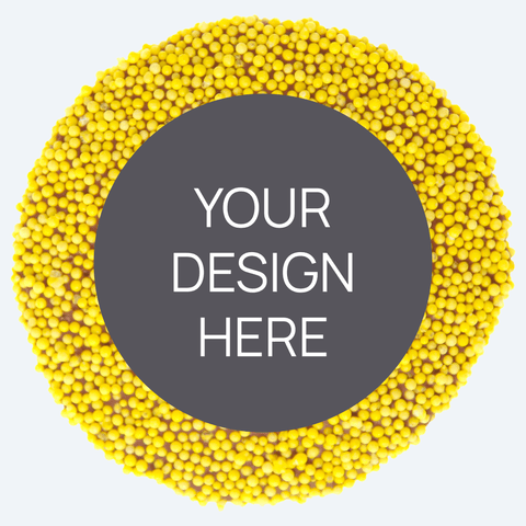 A custom product featuring a single round confectionery item with a colorful sprinkled border and a blank space in the center for a custom label, displayed alongside a selection of other colored sprinkles.