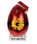 Red foil-wrapped chocolate egg with a yellow bow and Santa hat on a white background - add your corporate logo