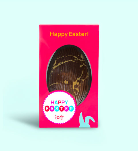 Caramel crunch and sea salt Easter egg styled with scattered caramel pieces and salt