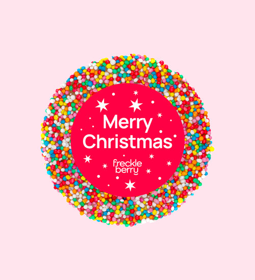 A colorful chocolate freckle with 'Merry Christmas' text and star decorations, individually wrapped.