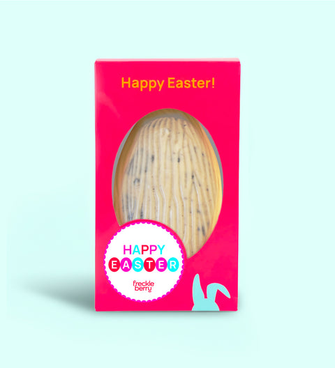 Close-up of cookies and cream Easter egg showing creamy white chocolate and cookie chunks