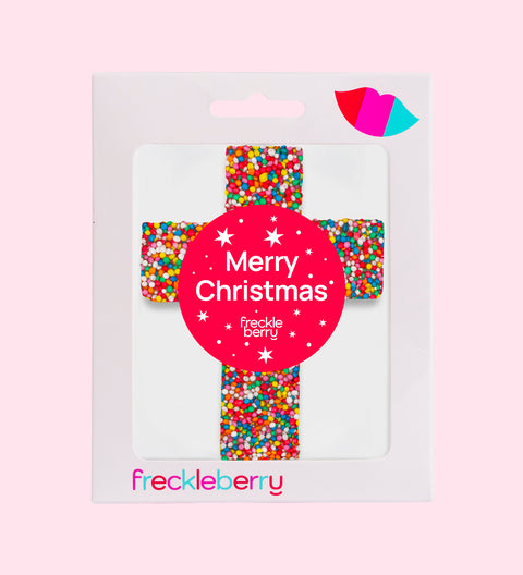 Religious cross make out of chocolate with Christmas Merry Christmas sticker