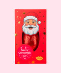 A festive red chocolate bar in a rectangular gift box featuring a cartoon Santa face and gold star accents, with a round red sticker that reads 'Merry Christmas' and a small yellow 'feetfeet' logo near the bottom.