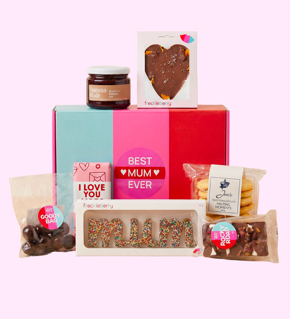 Assorted gift items including a box, cookies, and a heart-shaped chocolate on a pink background. A perfect gift for mothers day