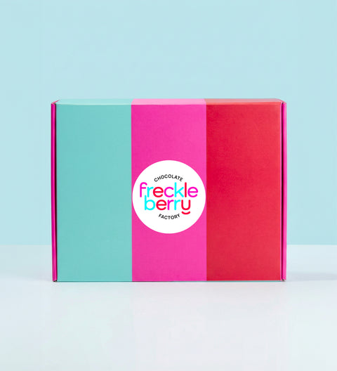 Colorful hamper gift box with 'Freckle Berry' logo on a light blue background