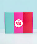 Colorful hamper box with a 'LOVE YOU' sticker on a light blue background