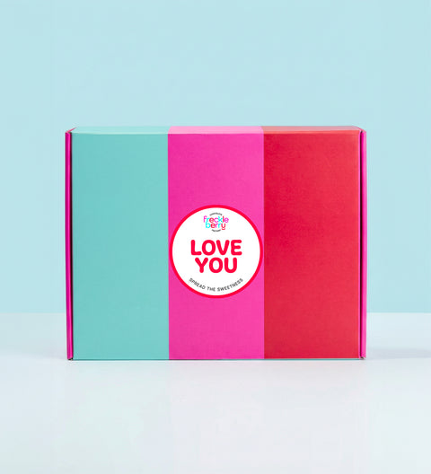 Colorful hamper box with a 'LOVE YOU' sticker on a light blue background