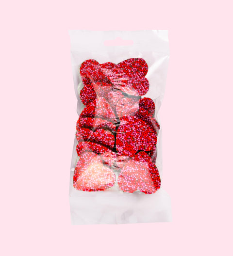Creamy Belgian milk chocolate freckles shaped like hearts, perfect for gifting or celebrating special moments.