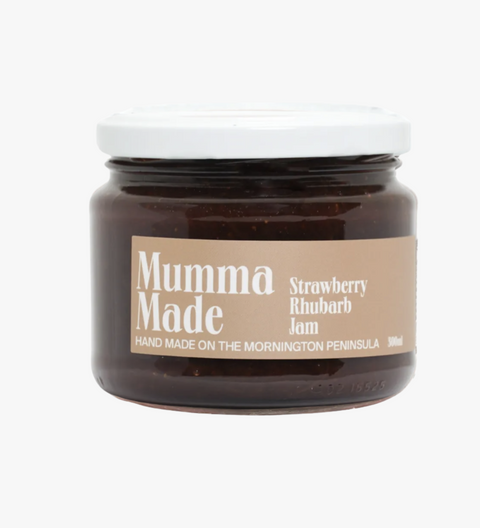 Jar of strawberry rhubarb jam with 'Mumma Made' label on a white background