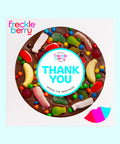 A chocolate pizza with an assortment of lollies and a 'THANK YOU' message in the center.