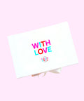 White box with 'WITH LOVE' text in colorful letters on a pink background